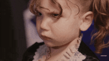 a close up of a little girl 's face with the words subscribe visible in the corner
