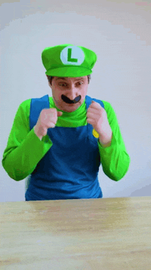 a man in a luigi costume with a l on his hat