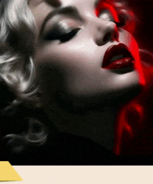 a close up of a woman 's face with red lipstick on