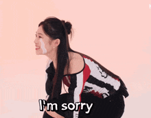 a woman kneeling down with a tear coming out of her eye and the words " i 'm so sorry " below her