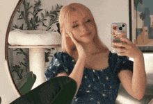 a woman taking a picture of herself in a mirror with a phone case that says ' i love you ' on it