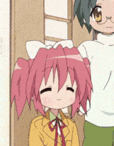 a girl with pink hair is standing next to a boy in a white shirt