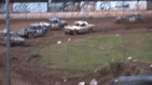 a john deere lawn mower is driving on a dirt road