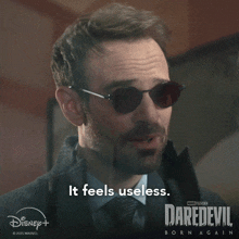 a man wearing sunglasses says it feels useless on a daredevil born again poster