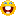 a blurred image of a yellow smiley face with its mouth open on a white background .