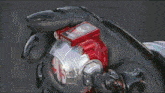a blurry image of a person 's face with a red object in the corner