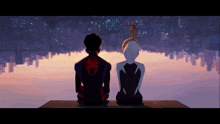 a man and a woman are sitting on a ledge looking at the city skyline