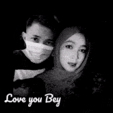 a man wearing a mask and a woman wearing a hijab hugging with the words love you bey written below them