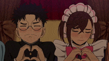 a boy and a girl making a heart with their hands