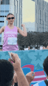 a woman in a pink tank top with a name tag that says goss on it