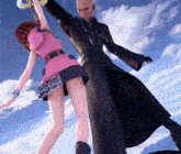 a man in a black coat is standing next to a woman in a pink skirt