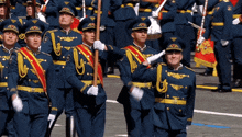a group of men in military uniforms are marching