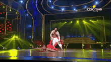 a man and woman are dancing on a stage with the words colors hd on the bottom