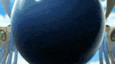 a large blue sphere with wings and green eyes