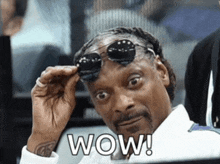 snoop dogg is wearing sunglasses and has the word wow written on his face