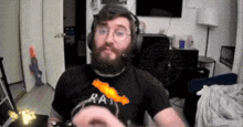 a man with a beard is wearing a black shirt that says rat