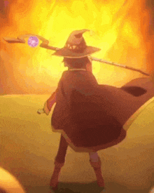 a person in a witch hat is holding a wand in front of a fireball .