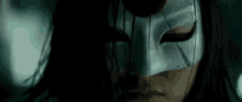 a close up of a woman wearing a mask with blood coming out of it 's eyes .