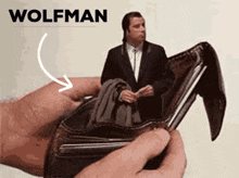 a person is holding a wallet with a picture of a man in it and the word wolfman on the top