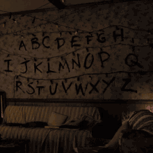 a dark room with the letters abcdefghijklmnopqrstuvwxyz painted on the wall