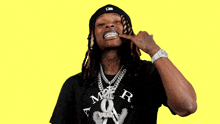 a man with dreadlocks is wearing a black t-shirt that says a more