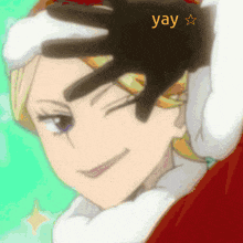 a woman wearing a santa hat has a hand on her forehead and the word yay is visible