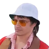 a man wearing a white hat and yellow sunglasses looks to the side