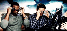 two men are covering their eyes with their hands in front of a marvel movie poster