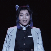 a woman with purple hair is wearing a cat ear costume
