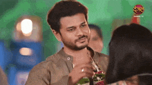 a man with a beard is talking to a woman with a dangal tv logo behind him