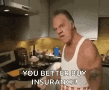 a man is standing in a kitchen talking about insurance .