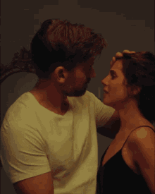a man and woman are looking into each others eyes