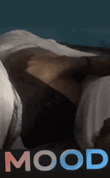 a picture of a person laying on a bed with the word mood below them