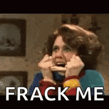 a woman is holding a piece of food in her mouth while talking on a phone .