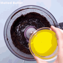 melted butter being poured into a food processor