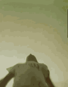 a blurry picture of a person 's shadow on a green background