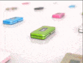 a green apple with a face is sitting on top of a green phone
