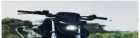 a close up of a motorcycle 's headlight with trees in the background .
