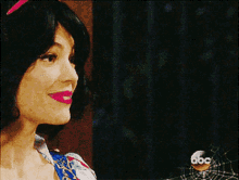 a woman in a snow white costume smiles while looking at a man