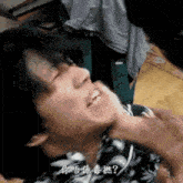 a man is being punched in the face with chinese writing on it