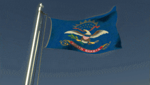 a blue north dakota flag with an eagle on it