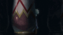 a person is standing in front of a vase with a red white and gold design on it