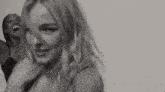 a black and white photo of a woman in a bra .