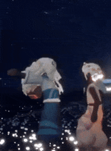 a couple of people are standing next to each other in a field of flowers at night .