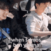 two young men are sitting in the back seat of a car laughing .
