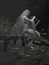 a woman in a veil is playing a harp