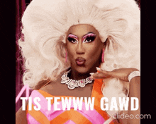 a drag queen blowing a kiss with the words tis tewww gawd