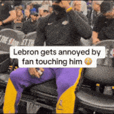 lebron gets annoyed by fan touching him in a basketball game