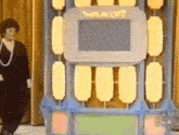 a woman is standing in front of a game show called who wants to win ?