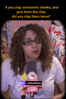 a woman with curly hair wearing glasses and a hello kitty t-shirt